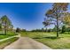 Expansive view of the golf course with a sidewalk and lush green fairways, perfect for leisurely walks at 2700 W Riverwalk Cir # C, Littleton, CO 80123