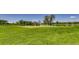 Well-manicured golf green with a flag and pond, offering a beautiful landscape for golf enthusiasts at 2700 W Riverwalk Cir # C, Littleton, CO 80123