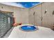 Private outdoor hot tub with a cover, nestled in a secluded area with a fence and neutral-toned walls at 2700 W Riverwalk Cir # C, Littleton, CO 80123