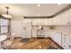 Well-lit kitchen with white cabinetry, modern appliances, and hardwood floors, offering a functional design at 2700 W Riverwalk Cir # C, Littleton, CO 80123