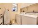 Functional laundry room equipped with a washer, dryer, and overhead storage, providing convenience at 2700 W Riverwalk Cir # C, Littleton, CO 80123