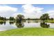 Scenic pond surrounded by lush greenery, offering a tranquil view with blue skies reflected in the water at 2700 W Riverwalk Cir # C, Littleton, CO 80123