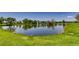 Scenic pond view surrounded by lush green grass and trees, reflecting a serene and peaceful atmosphere at 2700 W Riverwalk Cir # C, Littleton, CO 80123