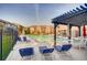 Outdoor pool area featuring poolside seating, pergola, and well-maintained landscaping at 2700 W Riverwalk Cir # C, Littleton, CO 80123