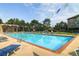 Inviting outdoor pool with clear blue water, surrounded by lounge chairs and decorative flags for a lively atmosphere at 2700 W Riverwalk Cir # C, Littleton, CO 80123