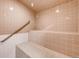 Clean tiled sauna room featuring multiple levels of seating and a handrail at 2700 W Riverwalk Cir # C, Littleton, CO 80123