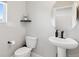 Stylish half bathroom featuring a pedestal sink and round mirror at 22025 E 45Th Ave, Aurora, CO 80019