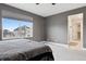 Comfortable bedroom featuring a large window and an ensuite bathroom at 22025 E 45Th Ave, Aurora, CO 80019