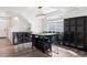 Bright dining area with a modern chandelier, dark wood floors, and black cabinetry providing lots of storage space at 22025 E 45Th Ave, Aurora, CO 80019