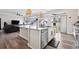 Open-concept kitchen with a large island, stainless steel dishwasher, seating and hardwood floors at 22025 E 45Th Ave, Aurora, CO 80019