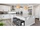 Bright kitchen features a large island, pendant lighting, stainless steel appliances, and sleek white cabinetry at 22025 E 45Th Ave, Aurora, CO 80019