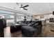 Spacious living room featuring a large sectional sofa, hardwood floors, and sun-filled windows at 22025 E 45Th Ave, Aurora, CO 80019