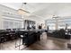 Spacious entertainment area with a black bar and dining table, sectional sofa, hardwood floors and high ceilings at 22025 E 45Th Ave, Aurora, CO 80019