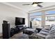 Cozy living room with sectional sofa, large TV, and view of the outdoors at 22025 E 45Th Ave, Aurora, CO 80019