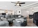 Open-concept living room featuring a large sectional sofa, hardwood floors and open access to the kitchen at 22025 E 45Th Ave, Aurora, CO 80019