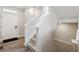 Bright staircase featuring neutral walls, carpeted stairs, and modern railing at 22025 E 45Th Ave, Aurora, CO 80019