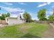 Backyard of home with possible lock out entrance, green lawn, mature trees, and perimeter fence at 8190 Raleigh Pl, Westminster, CO 80031