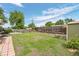 Spacious backyard featuring a lush lawn, wooden fence, garden beds, and mature trees, offering a private outdoor space at 8190 Raleigh Pl, Westminster, CO 80031