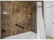 Beautiful bathroom with granite-look shower and chrome shower fixtures at 8190 Raleigh Pl, Westminster, CO 80031