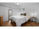 Bright bedroom featuring a plush bed, full length mirror, and hardwood floors at 8190 Raleigh Pl, Westminster, CO 80031