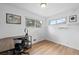 Bright home office with hardwood floors, large windows, and modern desk at 8190 Raleigh Pl, Westminster, CO 80031
