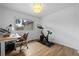 The bedroom features hardwood floors, a desk, a peloton and a window with natural light at 8190 Raleigh Pl, Westminster, CO 80031