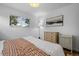Well-lit bedroom with large windows, hardwood floors, and a chest of drawers at 8190 Raleigh Pl, Westminster, CO 80031