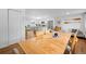 Open-concept dining area with hardwood floors, modern lighting, and a view of the kitchen at 8190 Raleigh Pl, Westminster, CO 80031