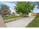 Charming home with a well-manicured lawn, mature trees, and a long driveway, creating inviting curb appeal at 8190 Raleigh Pl, Westminster, CO 80031