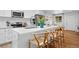 Bright kitchen featuring stainless steel appliances, white cabinetry, and an island with seating at 8190 Raleigh Pl, Westminster, CO 80031