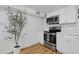 Cozy kitchen featuring stainless steel appliances and bright white cabinets at 8190 Raleigh Pl, Westminster, CO 80031