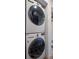 Stacked laundry machines with modern washer and dryer in a bright laundry space at 8190 Raleigh Pl, Westminster, CO 80031