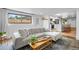Open floor plan reveals a cozy living room with an adjacent modern, white kitchen at 8190 Raleigh Pl, Westminster, CO 80031