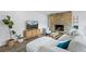 Comfortable living room with a stone fireplace, TV, modern decor, and ample seating at 8190 Raleigh Pl, Westminster, CO 80031