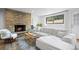Bright living room features a stone fireplace, plush sectional sofa, and large windows at 8190 Raleigh Pl, Westminster, CO 80031