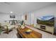 Bright living room features a modern design, a large TV, a coffee table, and an area rug at 8190 Raleigh Pl, Westminster, CO 80031