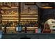 Inviting bar area with fully stocked shelves, a cozy brick arch, and ambient lighting at 2010 Pearl St # B, Boulder, CO 80302