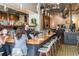 Stylish bar area with a wooden countertop, pendant lighting, and exposed brick, creating a warm ambiance at 2010 Pearl St # B, Boulder, CO 80302