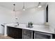 Wet bar featuring a sink, wine refrigerator, and sleek black cabinetry perfect for entertaining guests at 2010 Pearl St # B, Boulder, CO 80302