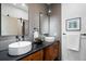 Elegant bathroom with dual sinks, wood cabinets, and stylish mirrors at 2010 Pearl St # B, Boulder, CO 80302