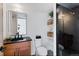 Modern bathroom showcasing a black granite countertop, tiled shower, and floating shelves for storage at 2010 Pearl St # B, Boulder, CO 80302