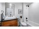 Modern bathroom with white tiles, wood vanity, and shower/tub combo at 2010 Pearl St # B, Boulder, CO 80302