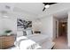 Cozy bedroom boasts white bedding, modern art, and light-colored furnishings at 2010 Pearl St # B, Boulder, CO 80302