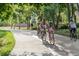 Scenic bike path with families enjoying a leisurely ride under the shade of lush trees at 2010 Pearl St # B, Boulder, CO 80302