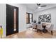 Dining area with modern table, chairs, artwork, and a view of the front entrance at 2010 Pearl St # B, Boulder, CO 80302