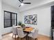 Bright dining area featuring a modern table setting, stylish chairs, and contemporary artwork on the wall at 2010 Pearl St # B, Boulder, CO 80302