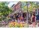 Charming downtown area with people strolling amidst colorful flowers and historic buildings on a sunny day at 2010 Pearl St # B, Boulder, CO 80302