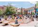 Scenic view of a bustling downtown area with people enjoying a water fountain feature on a sunny day at 2010 Pearl St # B, Boulder, CO 80302