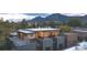 An exterior shot of a contemporary residence showing roof deck, wood and metal accents, and mountain views at 2010 Pearl St # B, Boulder, CO 80302