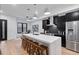 Contemporary kitchen featuring a large island with bar seating, stainless steel appliances, and dark cabinetry at 2010 Pearl St # B, Boulder, CO 80302